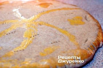 Змастити фокаччу оливковою олією або яєчним жовтком Змастити фокаччу оливковою олією або яєчним жовтком