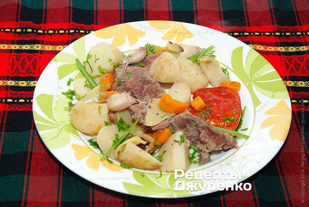 Во время трапезы выкладывать ложкой мясо с овощами и молодым картофелем на тарелку, посыпая блюдо мелко нарезанной петрушкой.