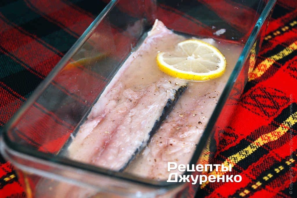 Рыбу по вкусу посолить, поперчить, и залить маринадом.