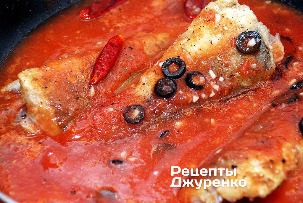 Влить к рыбе с оливками томатное пюре.