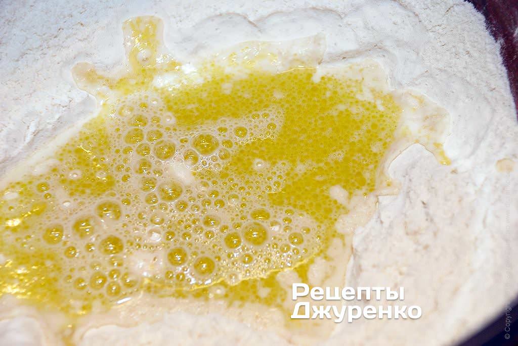 Mix water and olive oil, pour into flour.