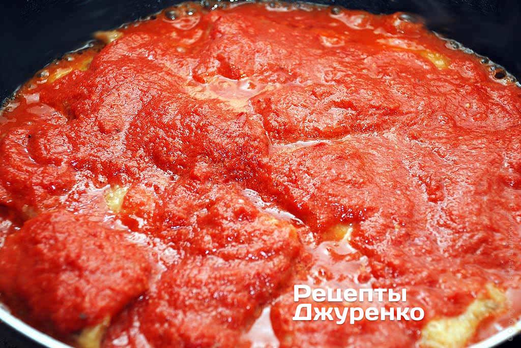 Як тільки риба готова, акуратно залити її прямо на сковорідці підготовленим овочевим пюре з томатами.