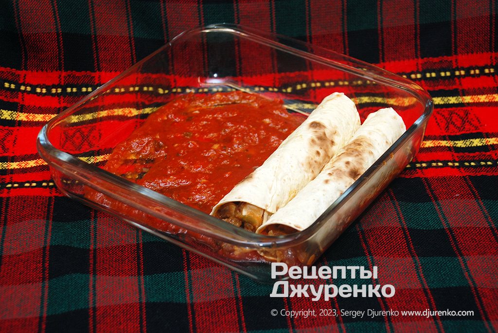 Wrap the filling in tortillas and place in a baking dish over the sauce.