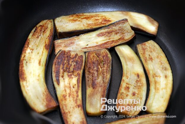 Roasting the eggplants in a small amount of oil.