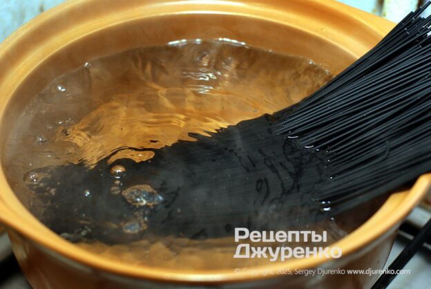 Cook the black pasta al dente.